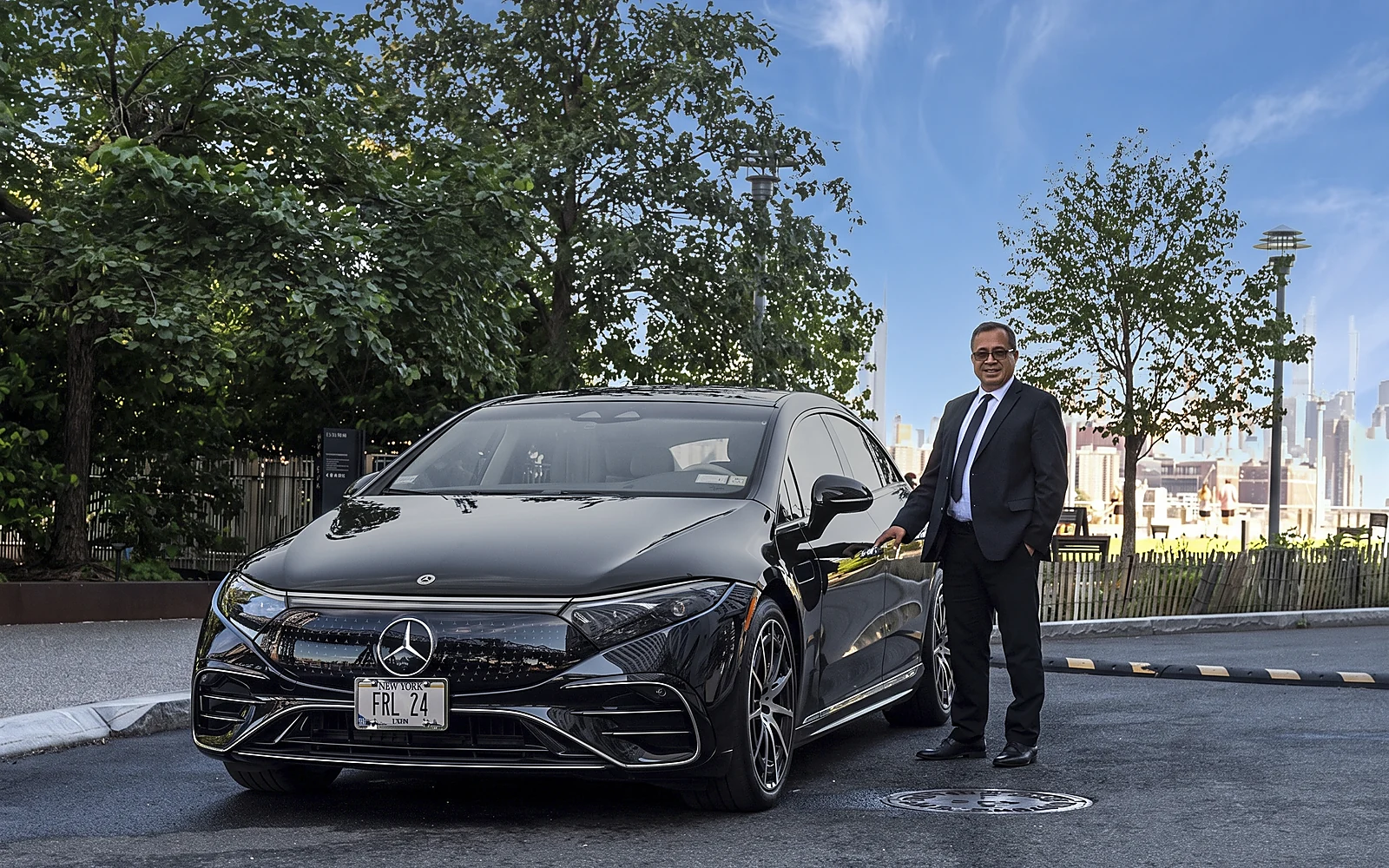 Friendly Ride chauffeur beside the Mercedes-Benz EQS 580 4MATIC
